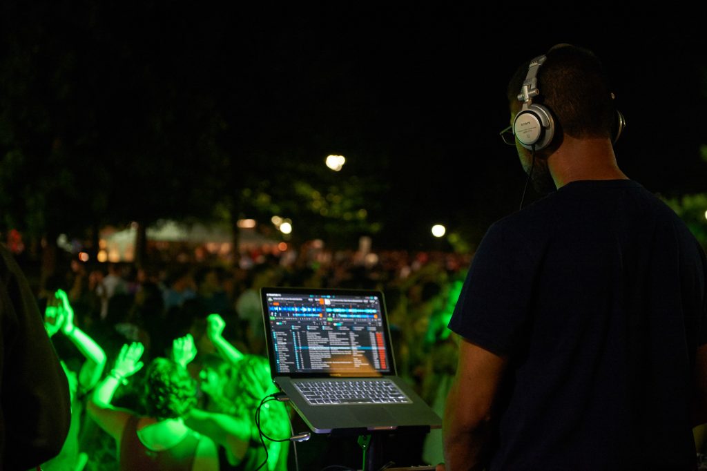A D. J. plays music for students dancing during the SUBOG Block Party along Fairfield Way on Aug. 29, 2015. (Peter Morenus/UConn Photo)